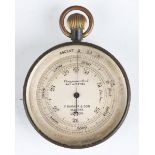 An early 20th century oxidized brass pocket barometer altimeter, the silvered dial detailed 'F.