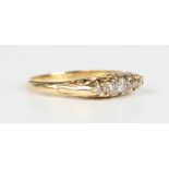 A gold and diamond five stone ring, mounted with a row of graduated cushion cut diamonds, the