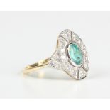A gold, emerald and diamond oval cluster ring, collet set with the oval cut emerald within an