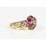 A Victorian gold, ruby and diamond cluster ring, claw set with the cushion cut diamond within a