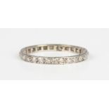 A diamond full eternity ring, mounted with circular cut diamonds, otherwise with engraved
