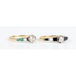 A gold, diamond and emerald ring, claw set with the cushion diamond between emerald set shoulders,