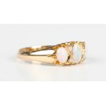 An Edwardian 18ct gold, opal and diamond ring, mounted with three oval opals and two pairs of rose