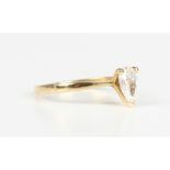 An 18ct gold and diamond solitaire ring, claw set with a pear shaped diamond, weight 2.5g, ring size