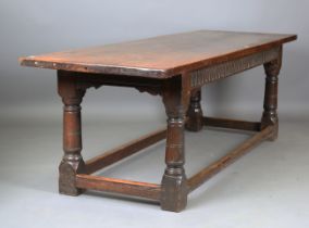 A 17th century oak refectory table, the three-plank top raised on turned and block legs, height