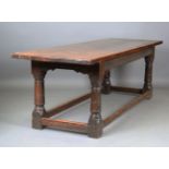 A 17th century oak refectory table, the three-plank top raised on turned and block legs, height