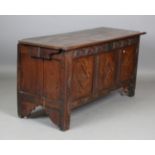 An early 18th century oak panelled coffer, the front inlaid with ebony and boxwood and later