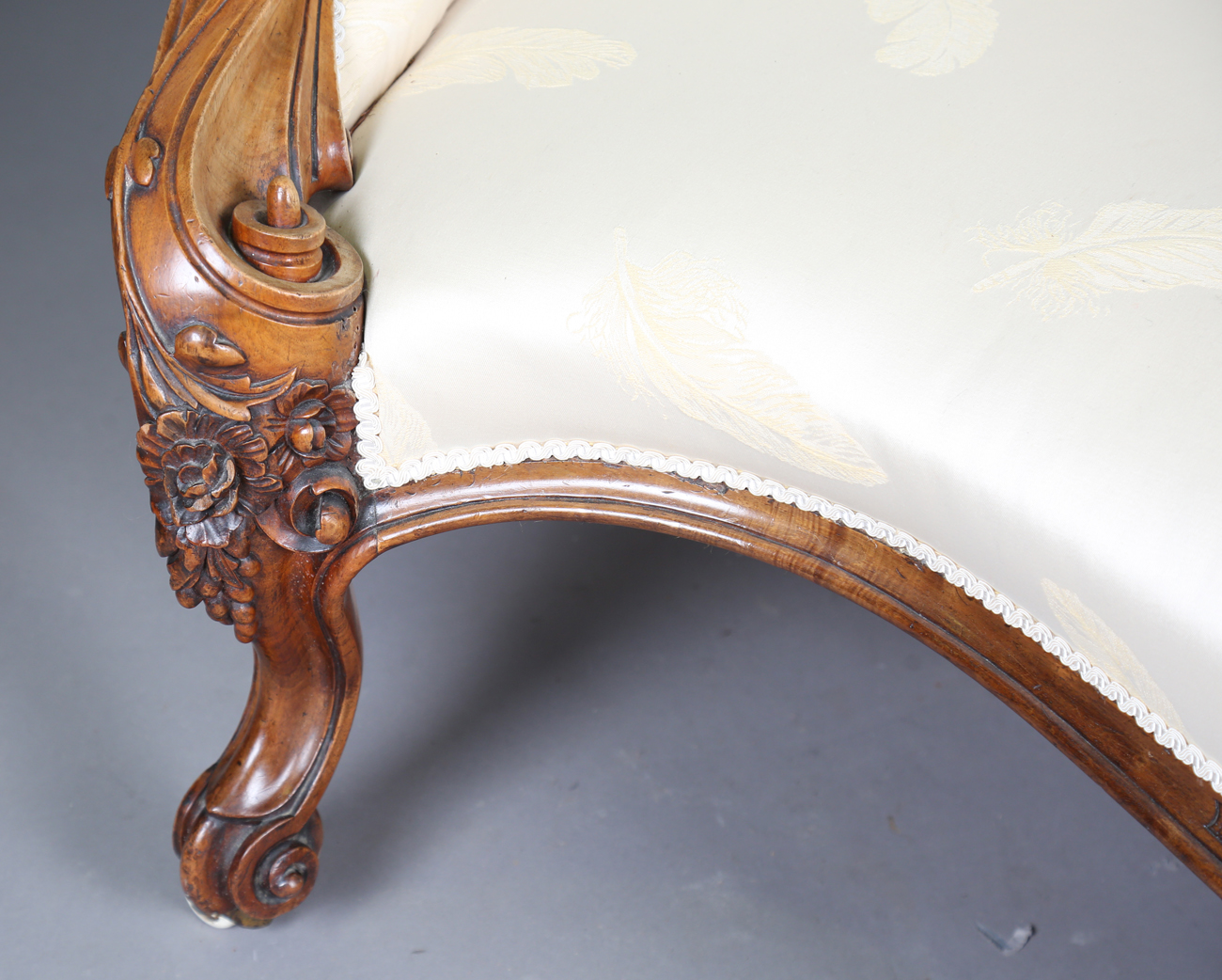 A fine mid-Victorian walnut showframe salon settee, the frame carved with flowers, leaves and fruit, - Image 8 of 11