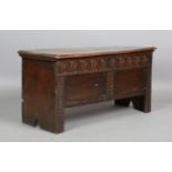 A late 17th century oak panelled and boarded coffer, the front later carved with lunettes, height