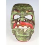A 20th century Japanese carved and painted wood kabuki mask with hinged jaw and applied hair