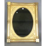 An early Victorian giltwood rectangular wall mirror with foliate mouldings and foliate cusp half
