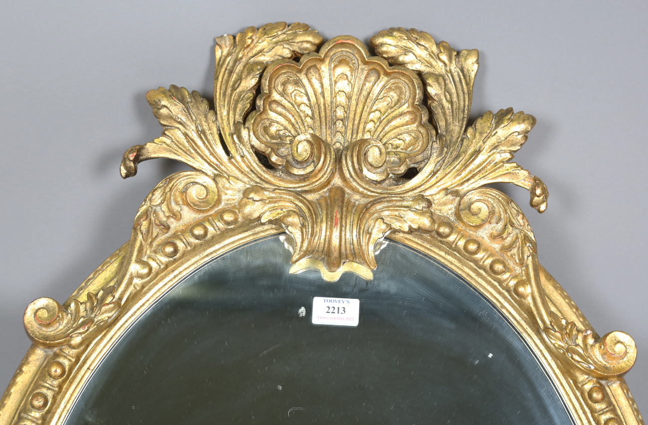 A 20th century rococo style gilt composition oval wall mirror with a shell surmount and scroll - Bild 4 aus 4