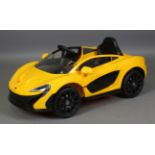 A modern electric child's ride-on toy car, modelled as a McLaren P1 by Avigo, length 125cm, boxed.
