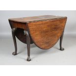 A George III Irish mahogany oval drop-flap dining table, the cabriole legs finely carved with