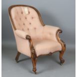 A mid-Victorian walnut showframe armchair, upholstered in buttoned fabric, height 93cm, width