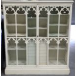 A 19th century Gothic Revival white painted softwood glazed cabinet, the two tracery moulded doors