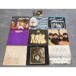 A collection of sixty-two LP records, including albums by The Beatles, Family, Focus and Queen,