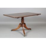 A Regency mahogany and rosewood crossbanded tip-top breakfast table, on downswept tripod legs,