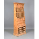 A 20th century pine kitchen dresser, fitted with a plate rack above nine drawers and a wine rack,