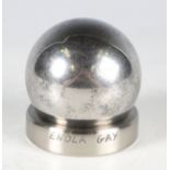 A 5cm diameter steel ball bearing and stand, purportedly from the Enola Gay Boeing B-29