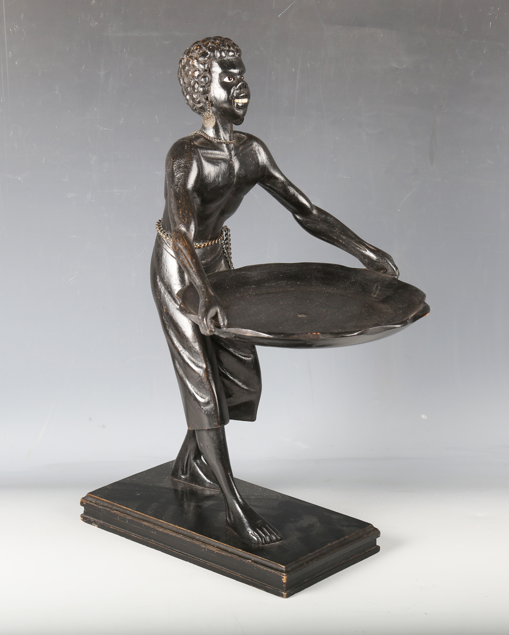A late 19th century ebonized carved wooden blackamoor table-top visiting card tray, modelled in