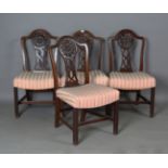 A set of four George III style mahogany dining chairs, the arched backs above pierced splats