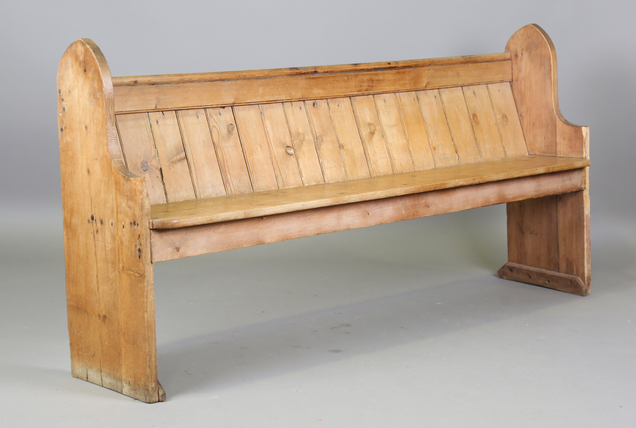 A 19th century pine pew with arched ends, height 89cm, width 186cm, depth 38cm.Buyer’s Premium 29.4%