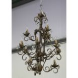 A late 20th century tole painted wrought metal twelve-light chandelier with scrolling branches and