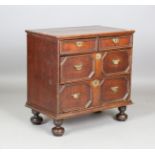A William and Mary oak chest of three drawers with applied geometric mouldings, on later bun feet,