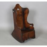 An early 19th century Welsh oak child's rocking armchair with pierced back and sides, height 74cm,