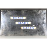 An Art Deco chromium plated 'Home Made Cakes' sign, inset with glazed white marble panels, height