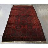 A large Beluche rug, Afghan/Persian borders, mid-20th century, the deep claret field with columns of