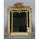 A 19th century gilt composition sectional wall mirror with a bird and quiver surmount above a beaded