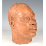 A 20th century terracotta bust portrait of a black man, height 27cm.Buyer’s Premium 29.4% (including