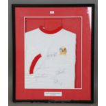 A vintage football shirt, signed by Manchester United footballers George Best, Dennis Law, Bobby