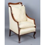 An Edwardian walnut framed armchair, upholstered in cream damask, height 109cm, width 65cm, together