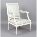 A Louis XVI white painted showframe fauteuil armchair, upholstered in floral patterned striped silk,