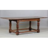 A 17th century style oak refectory table, raised on turned and block legs, height 73cm, length