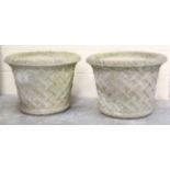 A pair of 20th century composition stone garden planters of tapering circular form with trellis work