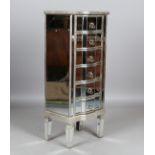 A modern mirrored and silvered chest of six drawers with shaped front, height 115cm, width 48cm,