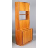 A mid-20th century G-Plan teak four-section wall unit, comprising a shelf, two cabinets and a chest,