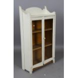 An early 20th century painted pine glazed bookcase, height 120cm, width 65cm, depth 28cm.Buyer’s
