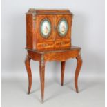 A mid-19th century kingwood and rosewood cabinet-on-stand with applied gilt metal mounts, inlaid
