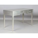 A modern Julian Chichester silvered dressing table with an inset mirrored top above three drawers,