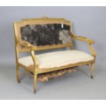 An early 20th century Louis XVI style giltwood settee with ribbon and rose surmount, on fluted