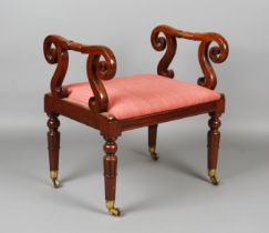 A William IV mahogany window seat with scrollwork arms and a padded drop-in seat, on tulip cusp legs