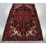 A Hamadan rug, North-west Persia, late 20th century, the charcoal field with a bold flowerhead
