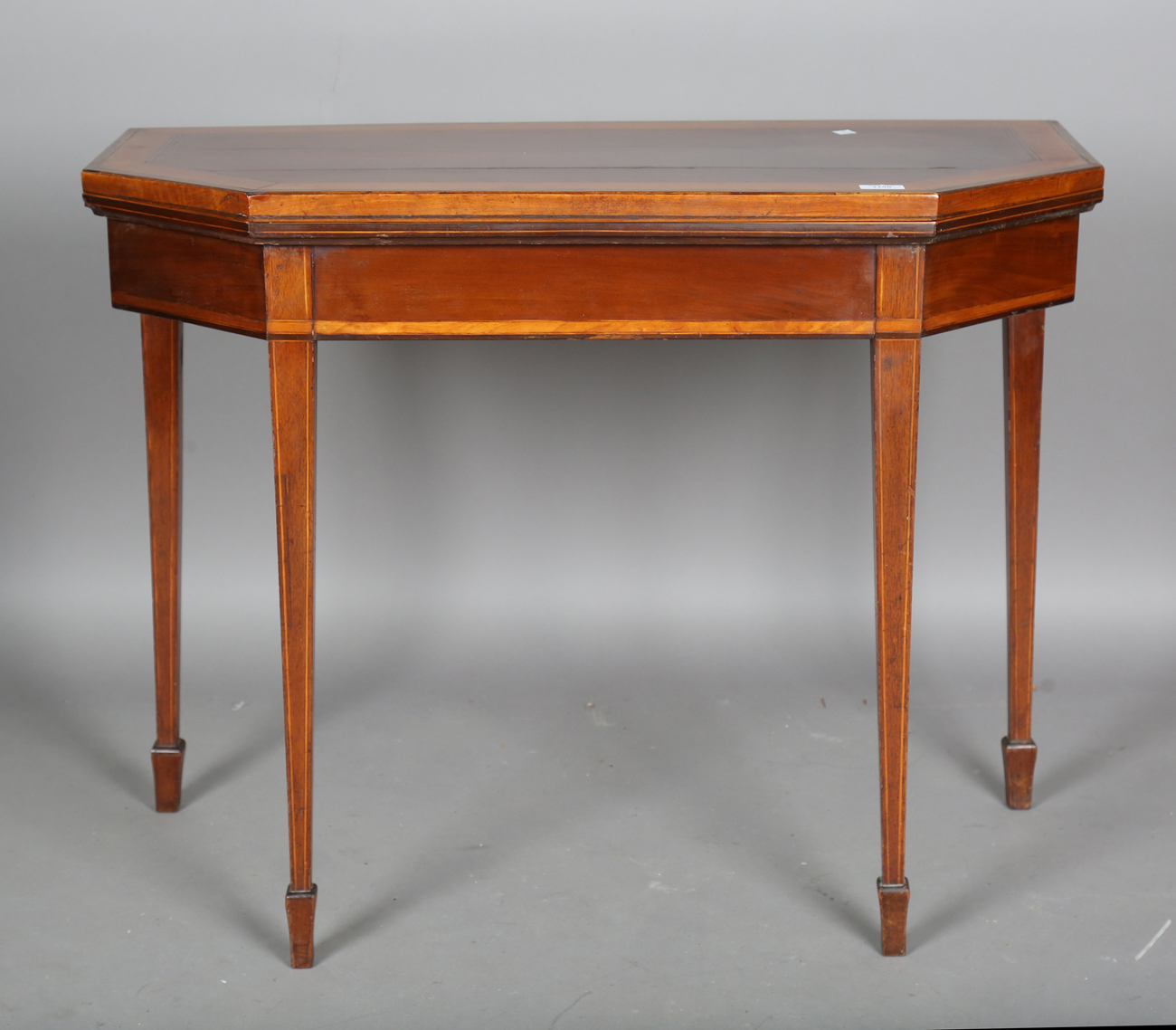 A George III mahogany fold-over card table with satinwood crossbanding, height 73cm, width 94cm,