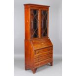 An Edwardian mahogany bureau bookcase, the fall flap inlaid with a conch shell, height 207cm,