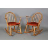 A pair of mid-20th century Ercol Windsor rocking armchairs, height 73cm, width 62cm, depth 71cm.